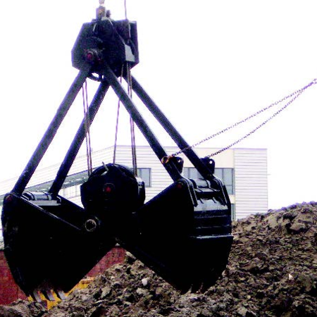 Dark rope grab in front of a large pile of rubble in an industrial area